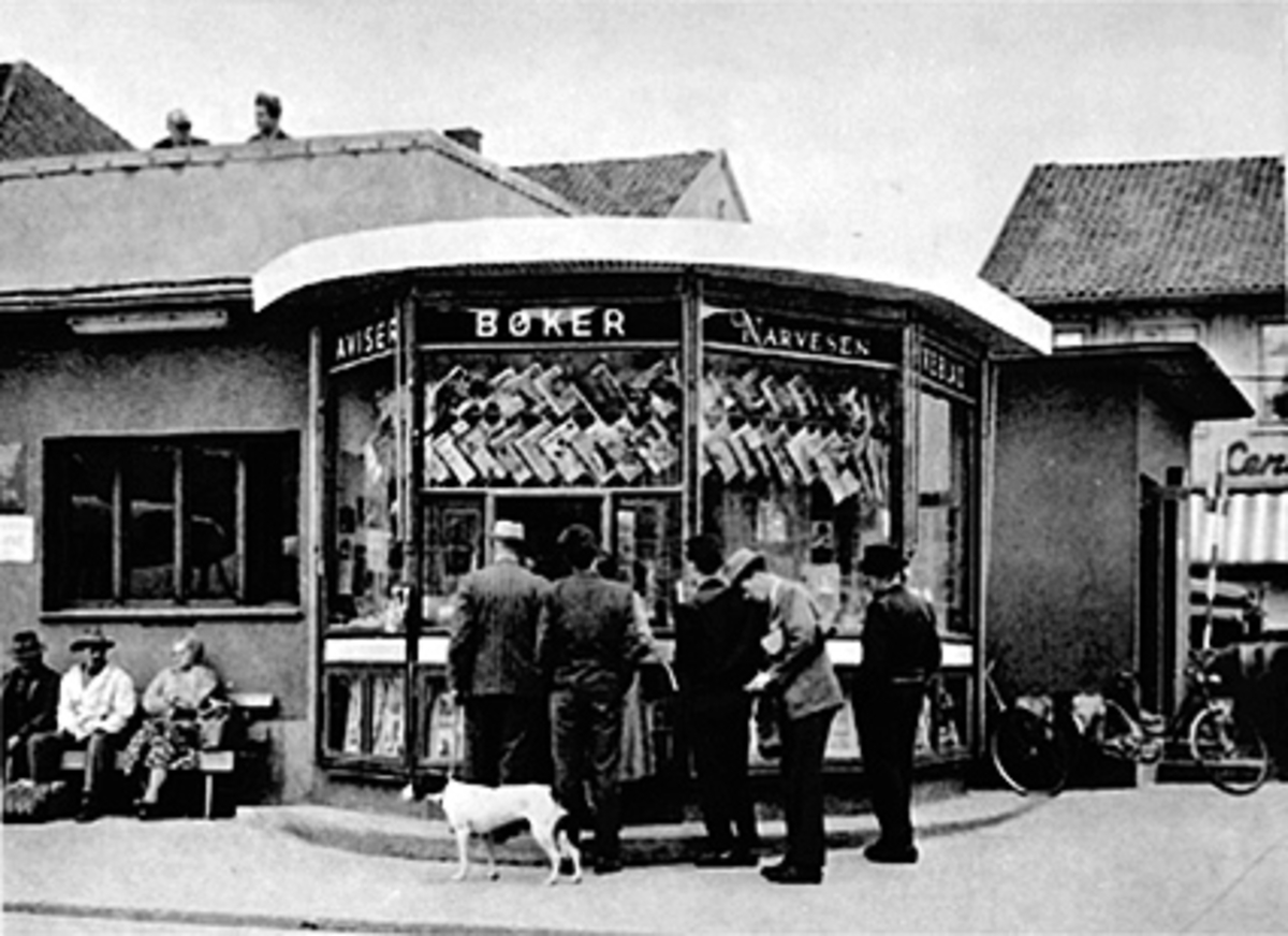 Anno Domkirkeodden, FOLK I KØ VED NARVESENKIOSKEN PÅ ØSTRE TORG, HUND, VENTEVÆRELSE FOR BUSSEN TIL VENSTRE FOLK PÅ BENK FORAN,