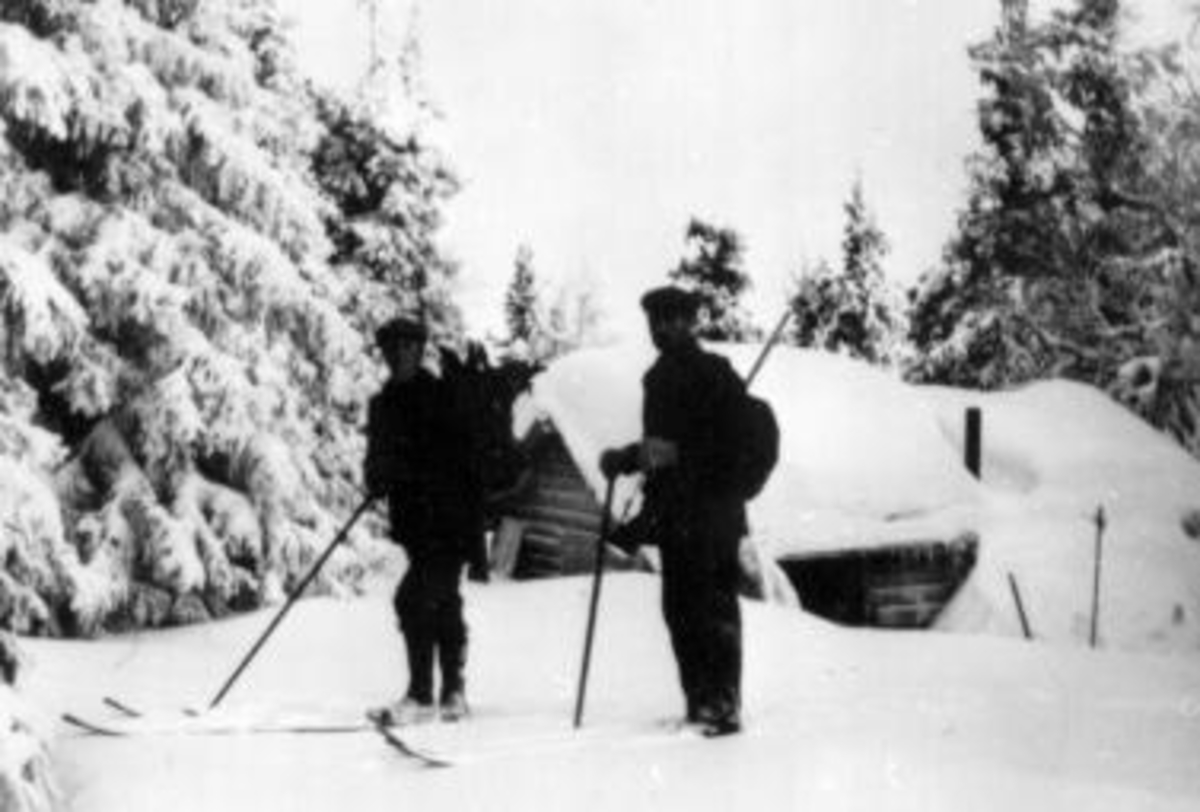 Anno Domkirkeodden, To menn på ski på rypejakt. Utenfor skogskoie.
