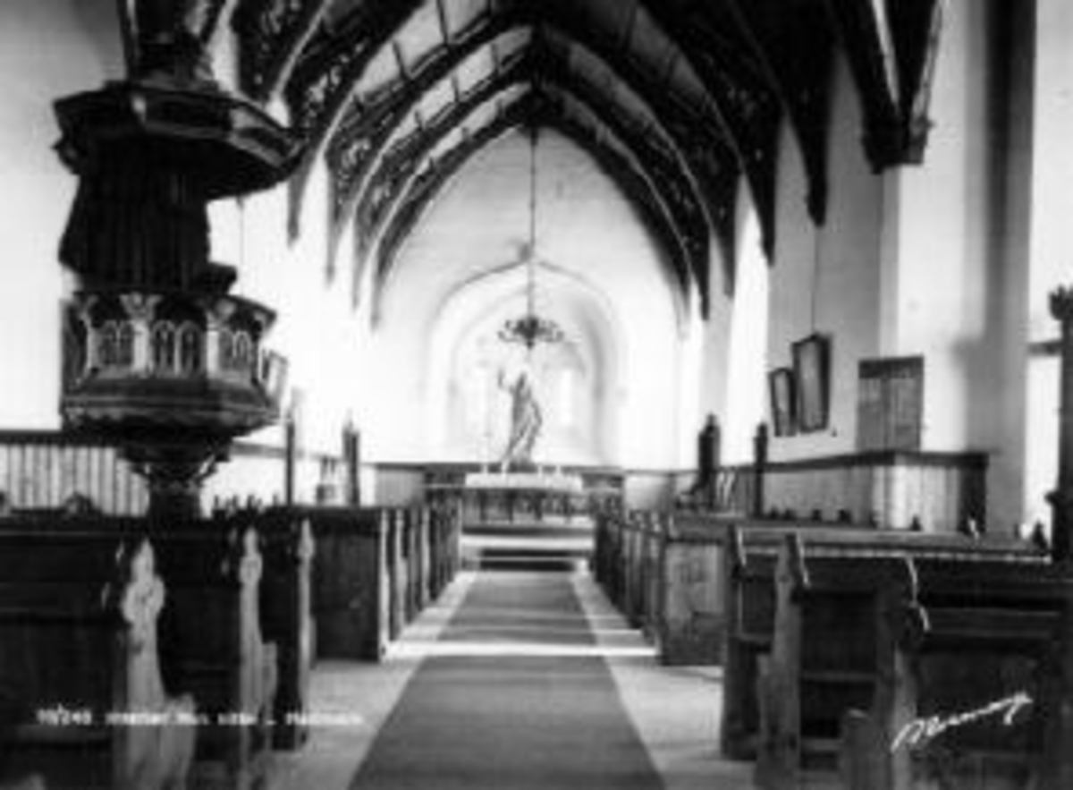 Anno Domkirkeodden, Interiør fra Nes kirke, Ringsaker. Prekestol, kristusfigur, benker.