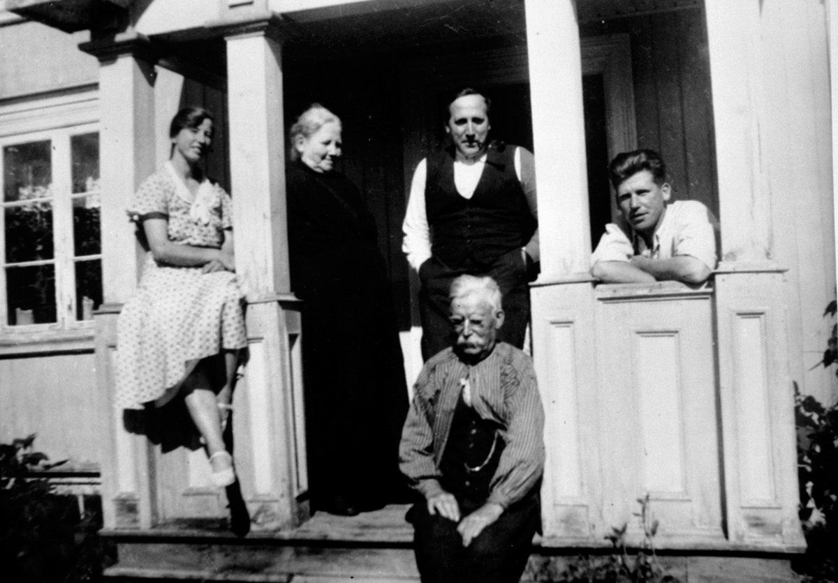 Anno Domkirkeodden, Gruppe på veranda. Magna Mæhlum f.Bjørklund, Johan Haugli, Magne Haugli. Foran Anders Haugli, Bakrud, Ringsaker.