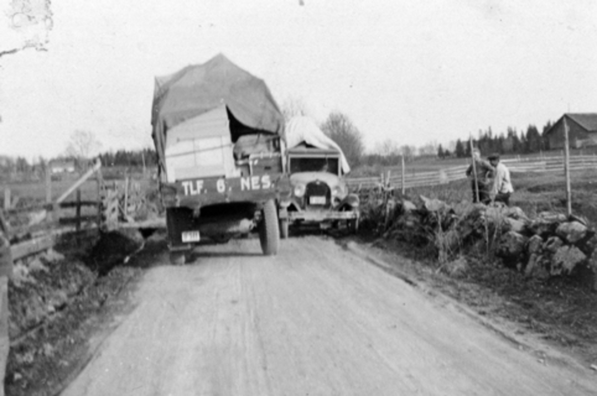 Anno Domkirkeodden, To biler møtes på smal bygdeveg. Til venstre med flyttelass er Chevrolet 1934 modell tilhørende Hoel gård, Nes, Hedmark med Emil Søberg som sjåfør. Til høyre er en Ford AA modell 1928-29.