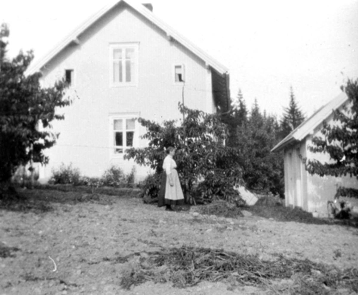 Anno Domkirkeodden, Fra hagen i Fagerli, Helgøya. Ukjent kvinne utenfor huset.