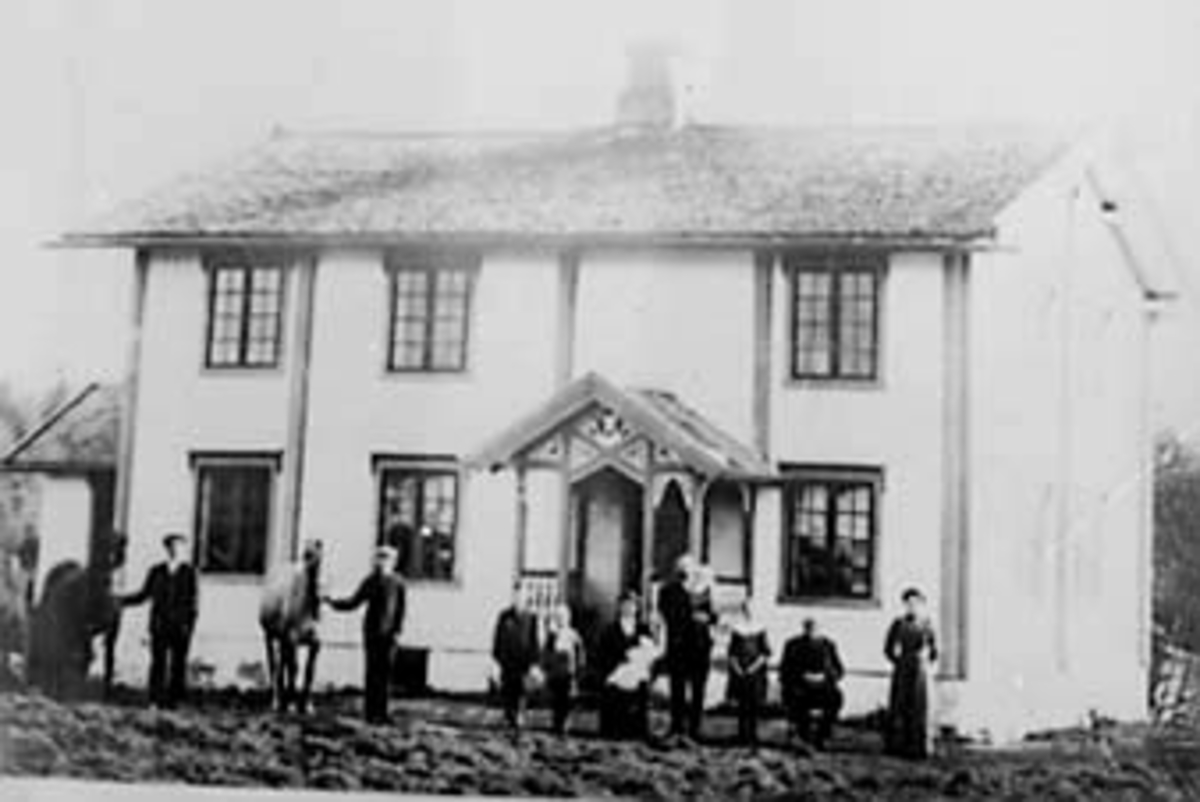 Anno Domkirkeodden, EKSTERIØR: HOVEDBYGNINGEN TINGSTAD, GRUPPE: 11 FORAN, FRA VENSTRE: ANDERS, KRISTIAN, OLE, EMMA MED RUDOLF PÅ FANGET, CHRISTIAN MED OLGA PÅ ARMEN, MARTHA, ANDERS MIKKELSEN, OLINE KLAFSTAD, ÅSVANG