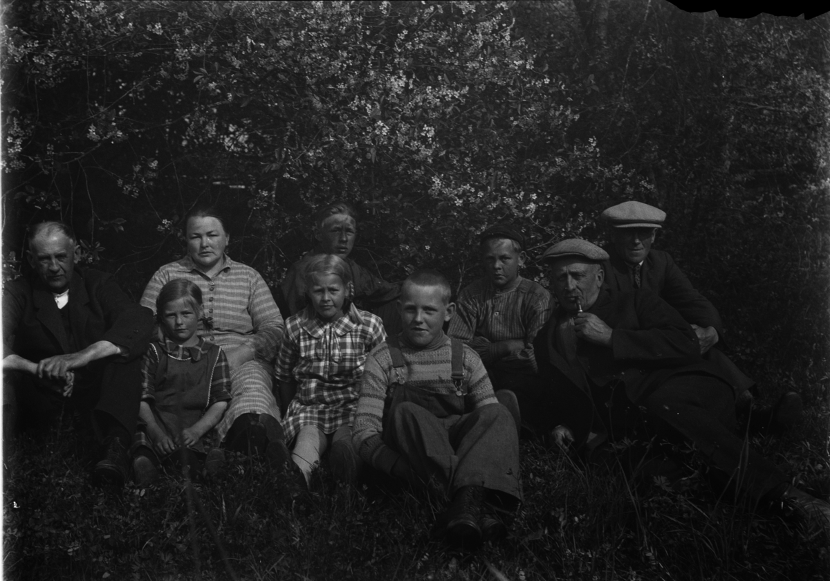 Mikkel Sveinhaug, Eksteriør, hagen på vestre Doglo, Furnes i Ringsaker. Bak f. v. Mikkel O. Dobloug (f. 1866), Agnete Johannesdatter Dobloug (f. 1887), Ole Dobloug (f. 1911), Jens Dobloug (f. 1913), Anders Dobloug (f. 1870) med pipe, Johannes Dobloug (f. 1888) på Seberg i Ringsaker. Barna foran: Anne Dobloug (Østby …