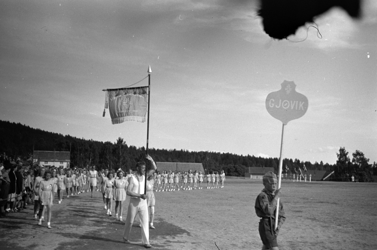 Håkon Prestkværn, Gjøvik turnforening som marsjerer på et turnstevne, Moelv Idrettspark, juni 1949.