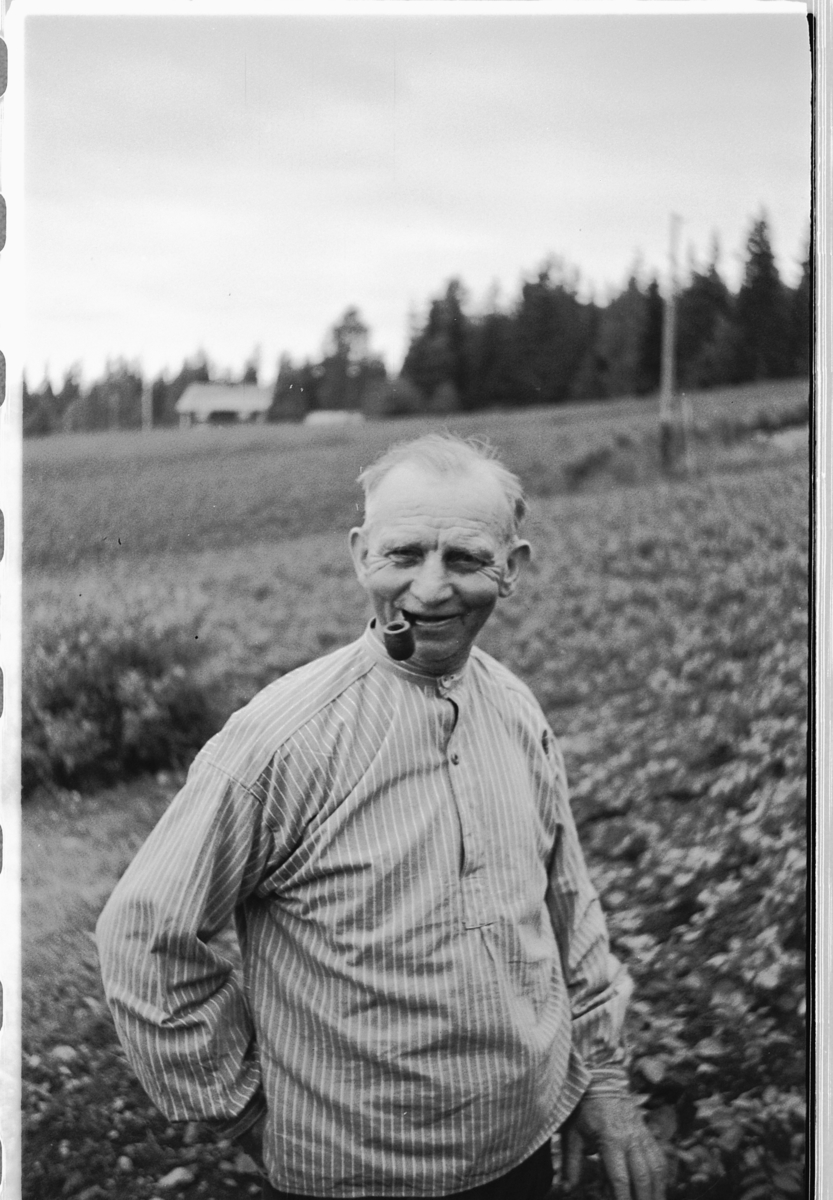 Håkon Prestkværn, Eldre mann med pipe foran et jorde.