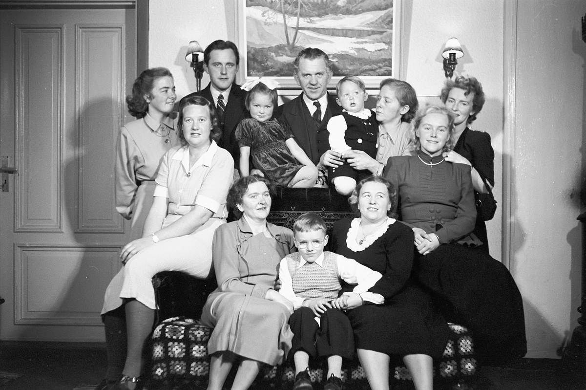 Håkon Prestkværn, Interiør, stue. Ukjent familiegruppe i en sofa.