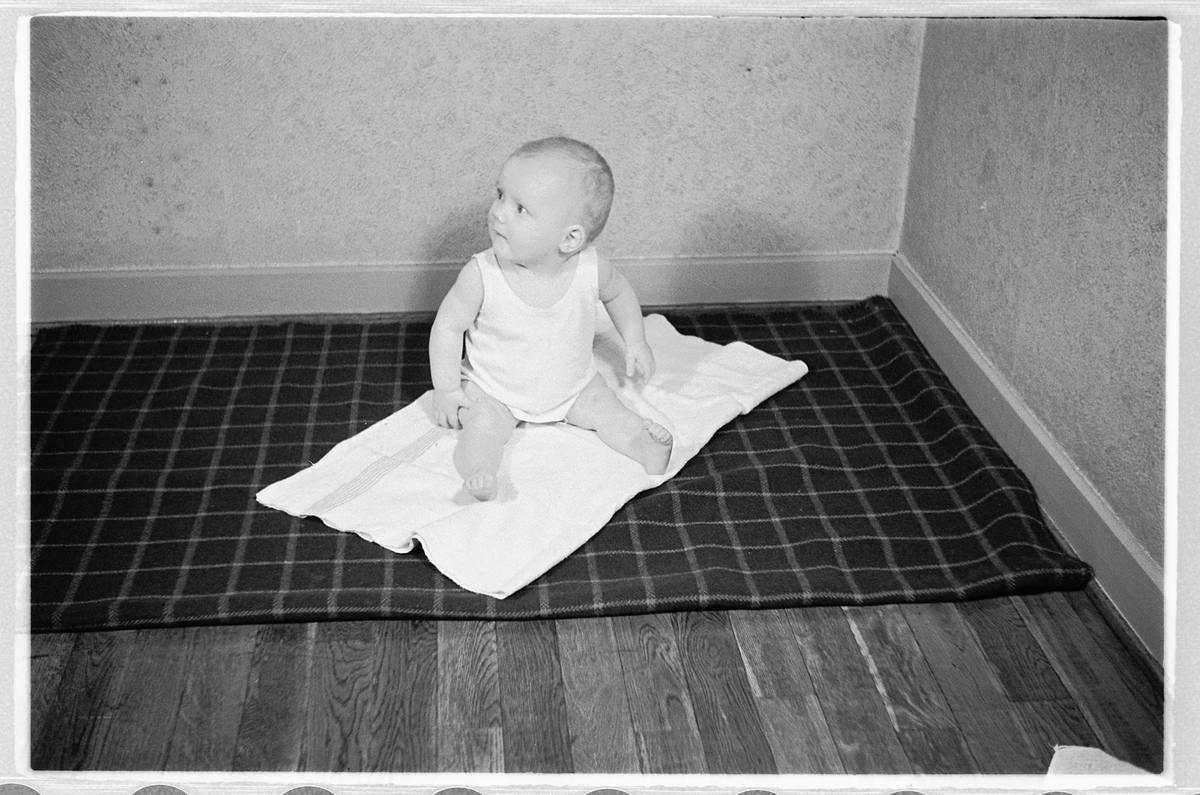 Håkon Prestkværn, En baby på et pledd.