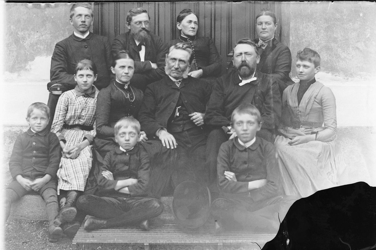 Hans Emil Erichsen, 12 voksne og barn ute. Ukjente.