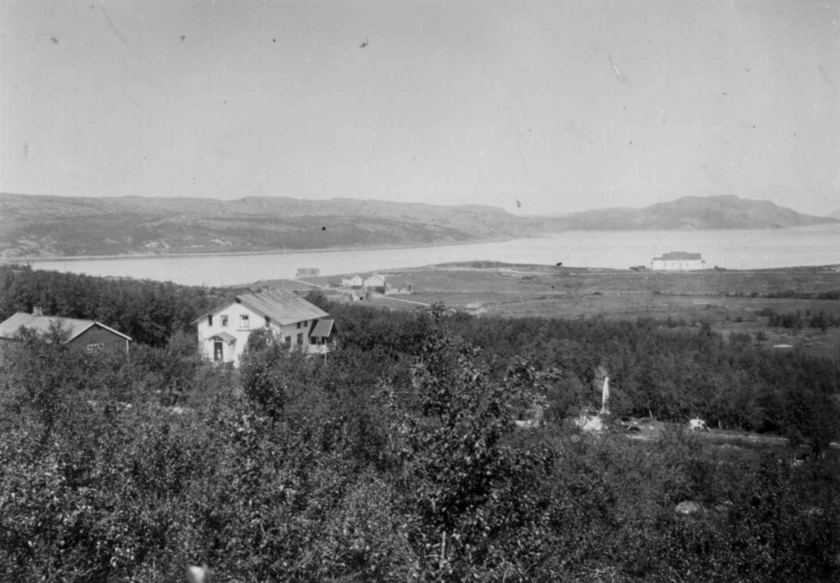 Ellisif Rannveig Wessel, Kirkenes kirke, Sør-Varanger, Finnmark, med prestegården, 1899. Nærmest ligger legeboligen for familien Wessel og lengst borte t. v. for kirken handelsmann Figenskous bolig.