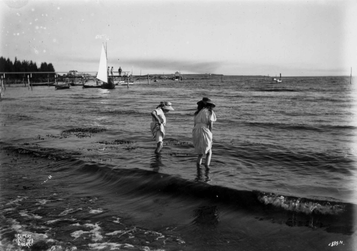 Hermann Christian Neupert, Larkollen, Rygge. 1910. Badescene ved Oslofjorden. Unge piker. Båtliv. Brygger.