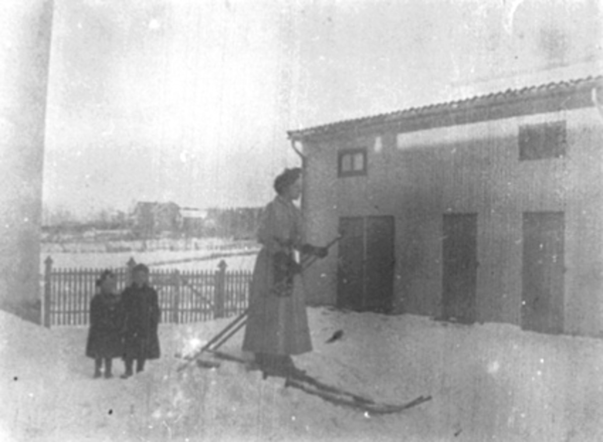 Anno Domkirkeodden, INGEBORG PETERSEN PÅ SKI I BAKGÅRDEN TIL SKOLEGATA 12, 2 SMÅPIKER SER PÅ, VINTER