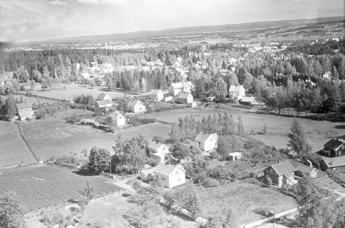 Widerøes Flyveselskap A/S, FLYFOTO ALUVEGEN/VOGNVEGEN, P. A. BERGS FORRETNING I MIDTEN