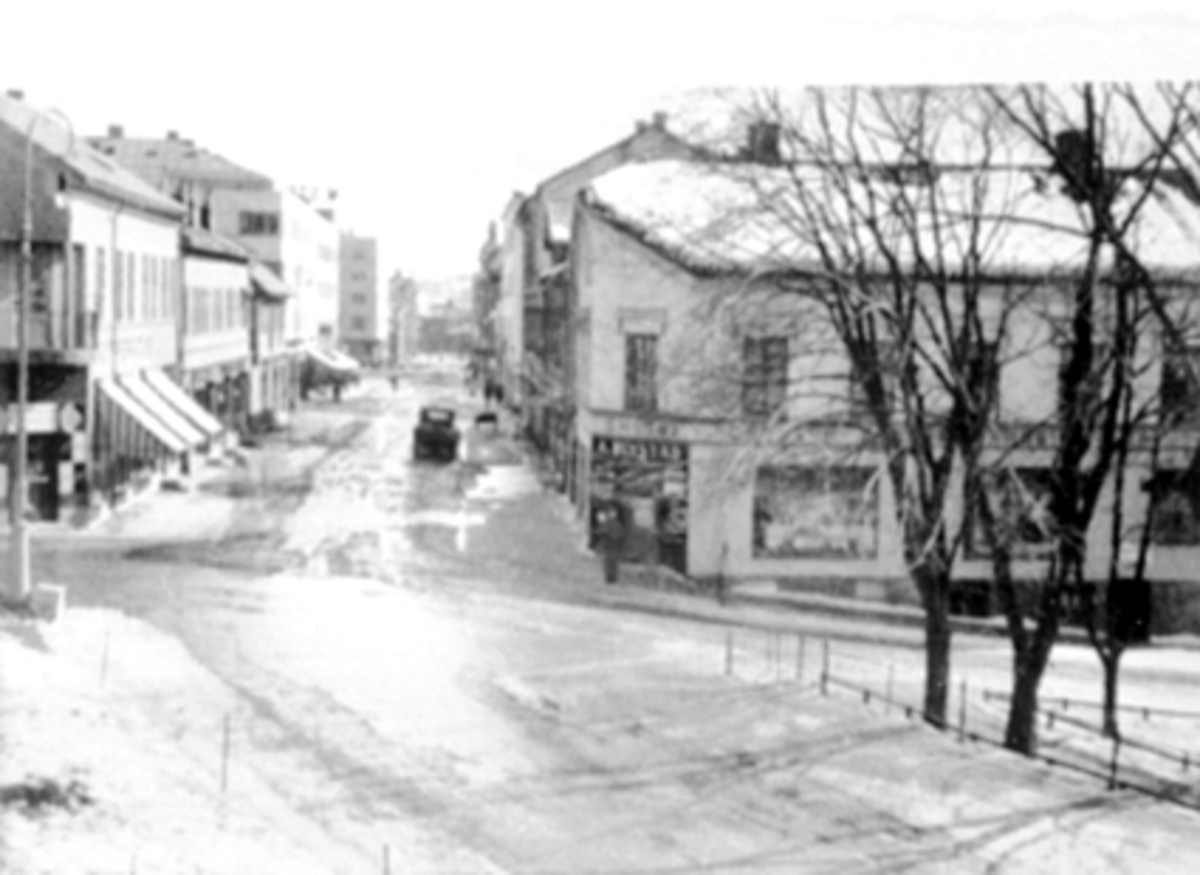 Anno Domkirkeodden, Torggata, Hamar. "Stille demonstrasjon" under 2. verdenskrig. Folketom gate. 1941. Det utgikk en parole fra London om at sivilbefolkningen skulle holde seg innendørs en viss tid på dagen. Bildet er tatt fra 2 etg. i "Triangelgården", Biblioteket, kemnerkontoret.