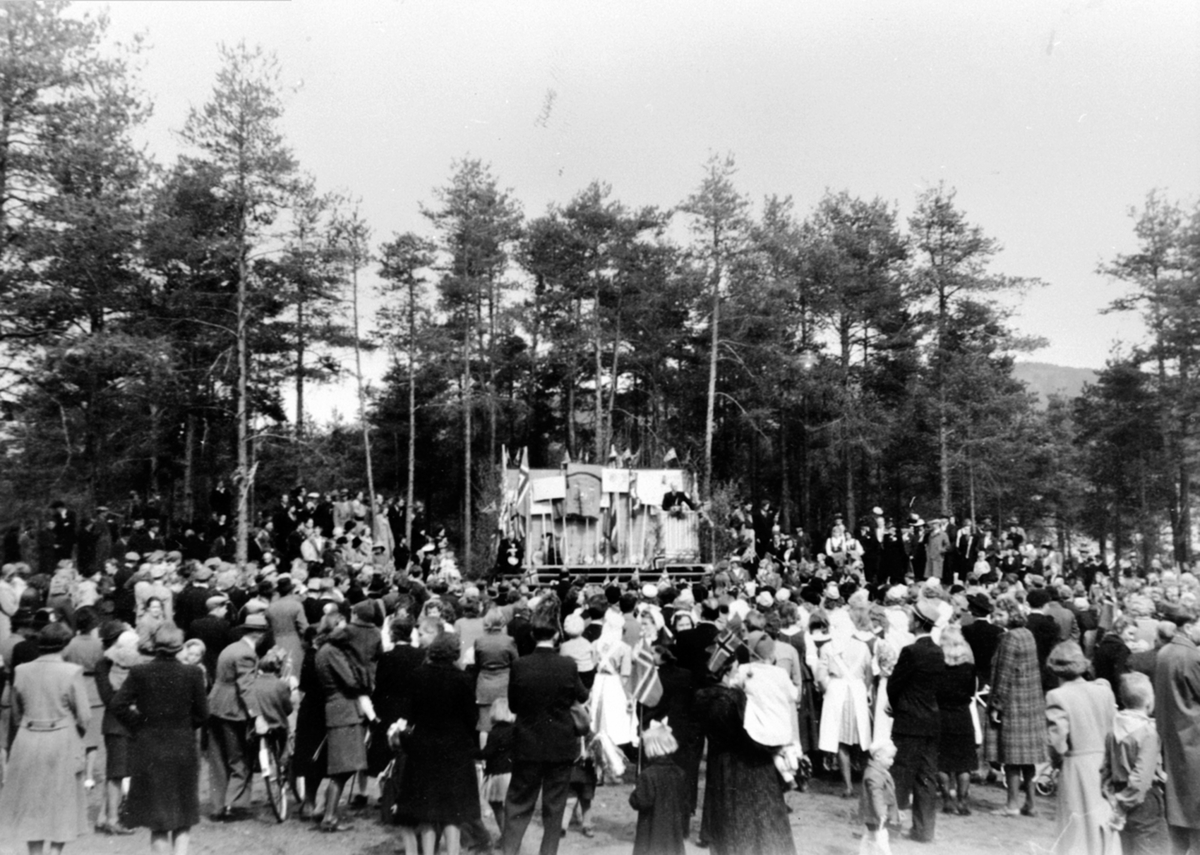 Anno Domkirkeodden, Sekretær i sjømannsmisjonen, prest Ingard Henriksen taler den 17. main 1946. Mye folk ved pyntet scene, Moelv.
