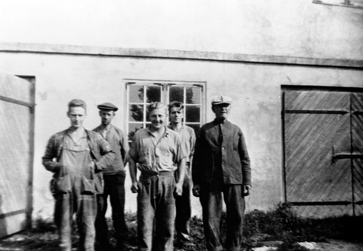 Anno Domkirkeodden, Fem arbeidere foran fjøset på Hovelsrud, Helgøya. Fra venstre er Oskar Slåttsveen, Reidar Bakken, Eivind Langseth, sveiser Jon Bakkestuen, Olivius Maurud.