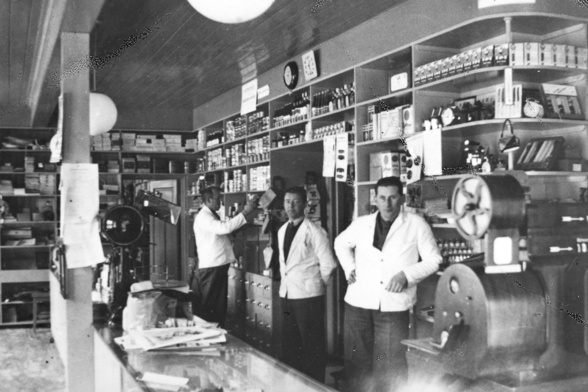 Ukjent, Moelv kooperative, interiør, butikk ca. 1938-1939. F. v. bestyrer Odd Skogstad, Magne Egeberg, Skurd Larsen.