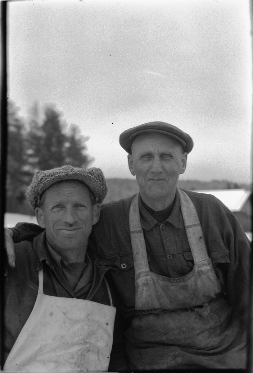 Håkon Prestkværn, To ukjente menn i arbeidsklær og sixpence. Mannen til venstre er Erling Bye som arbeidet ved sagbruket til Ringsaker Almenning på Buvika