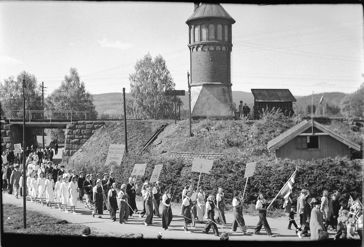 Håkon Prestkværn, MOELV, 17. -MAI-TOG, PLAKATER, NORSKE FLAGG, BUNADER, VANNTÅRN VED MOELV JERNBANESTASJON, JERNBANEUNDERGANG NEDERST I STORGATA.
