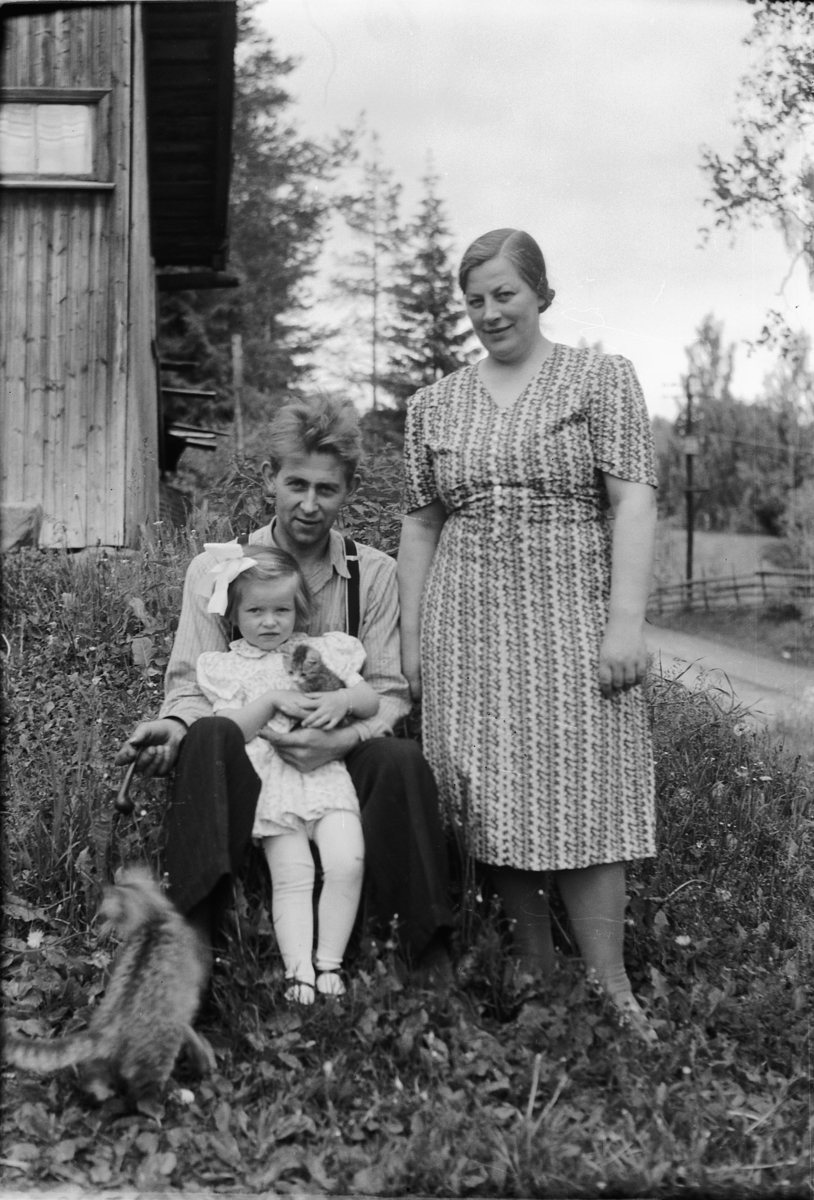 Håkon Prestkværn, Familien Lille-Mæhlum. Jørgen Lille-Mæhlum f. 2. 4. 1910 og Borghild f. 11. 5. 1907. Jorunn f. 28. 11. 1939. Åsmarkveien 49 i Moelv. Jorun holder i en liten kattunge.