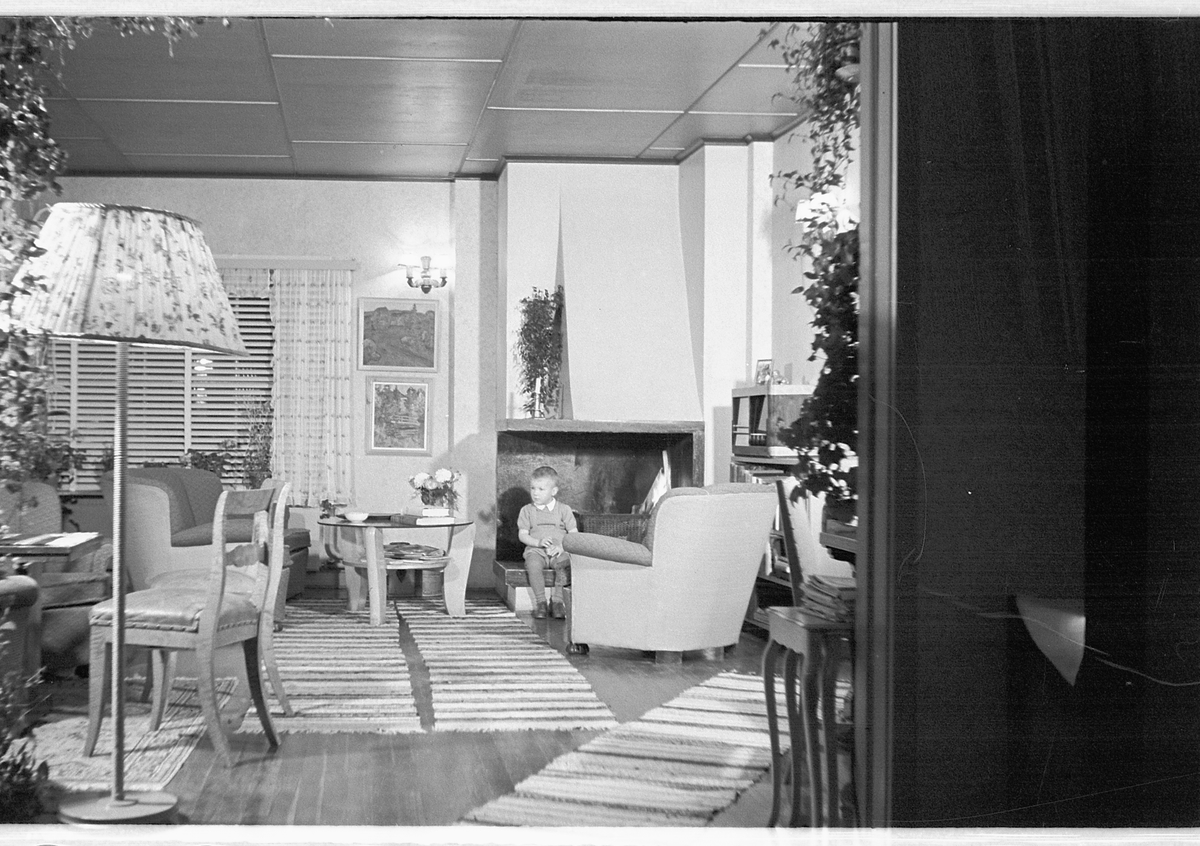 Håkon Prestkværn, Interiør, stue med sofa, stålampe og peis.