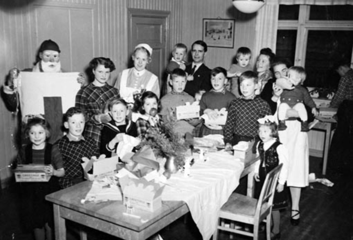 Anno Domkirkeodden, HAMAR RØDE KORS. UNGDOMMENS RØDE KORS DELER UT JULEGAVER PÅ BARNEHJEMMET. JULENISSE BARN OG VOKSNE. FOTO NORMANN, HAMAR 18. 12. 1949 SE OGSÅ NEG. NR. NO 37505