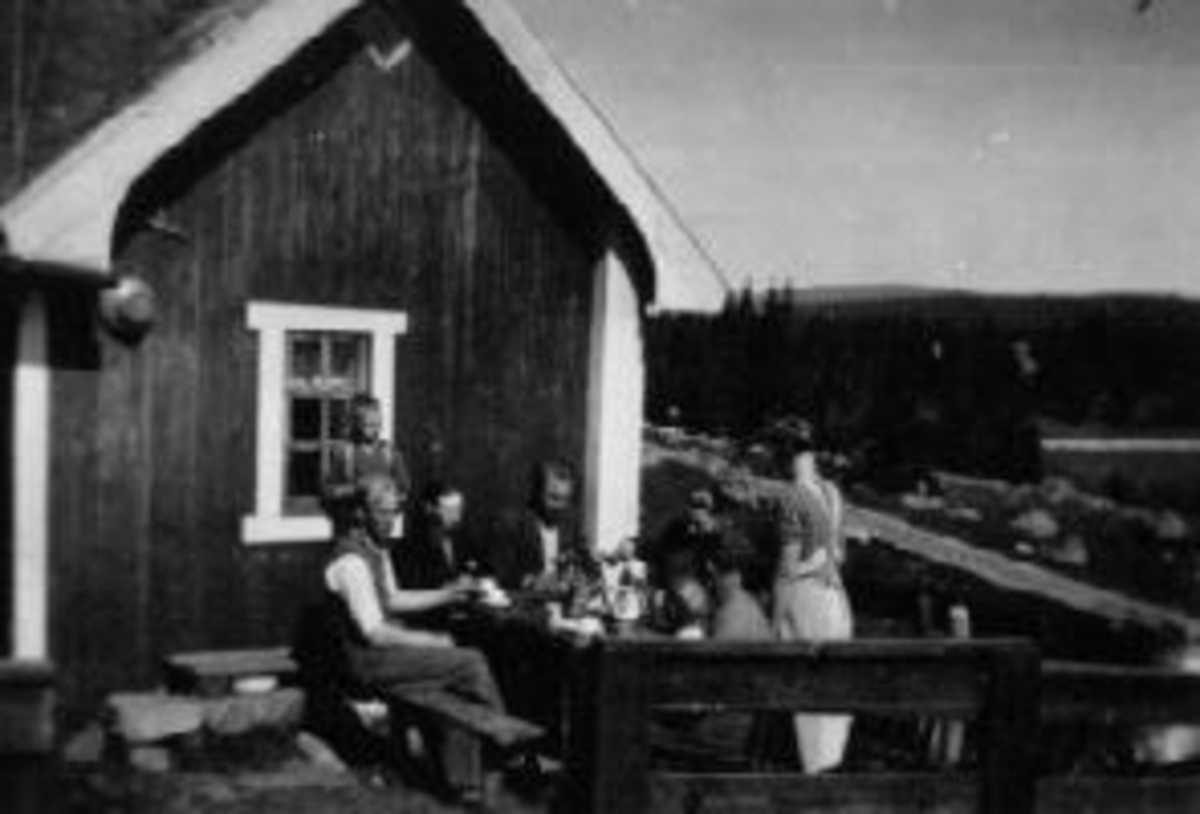Anno Domkirkeodden, Eksteriør, hytte med et rom på Gaalassetra på Olshølen. Foran er sjåfør Brattberg, Sverre Hovland, Hans Haugen, Anne D. Haugen, Gunnar Hovland, Sigurd Hovland, Gudrun Hovland.
