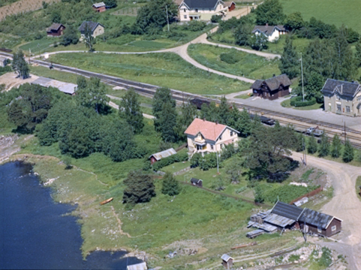 Widerøes Flyveselskap A/S, Flyfoto av bolig ved Jessnes stasjon, Ringsaker. Boligen tilhørte Hedemarken Potetmjølfabrikk. Disponentboligen ved potetmelfabrikken på Jessnes. Jessnesstranda 170. Jessnes stasjon i bakgrunn.