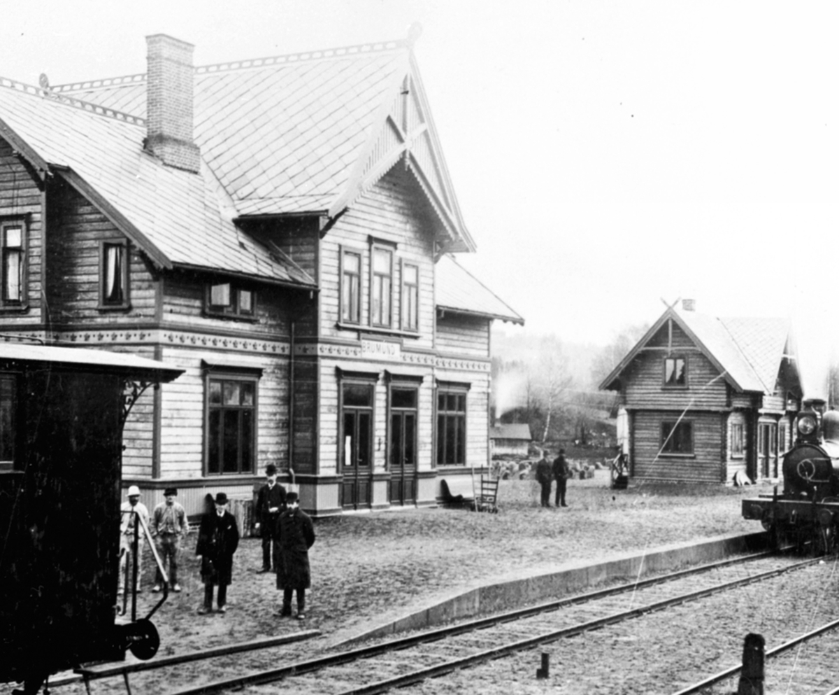 Anno Domkirkeodden, Eksteriør, Brumunddal jernbanestasjon, godshus, 7 menn på perrongen, merk navnet er Brumund.