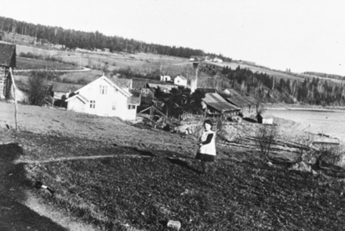 Anno Domkirkeodden, Svingen landhandleri, Mengshoel brygge. Låven i Karlstad til venstre. Bak er Mengshoel Teglverk og Verkenstua. Amalie Mengshoel drev landhandel og båtekspedisjon 1910-1917, Olaf Markestad 1917-1925. Fra 1925 overtok Jens Mengshoel. Piken i forgrunn er Sigrid Sørbo fra Bakkom.