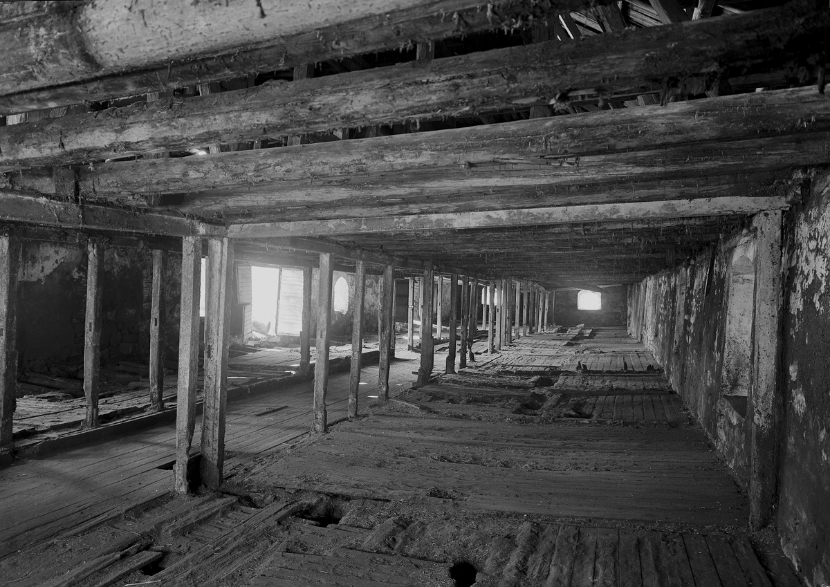 Normann Fotoatelier, Storhamarlåven, interiør, bygningskonstruksjoner. Fra fjøset i nordfløyen, sett mot vest. Her var det en gang båsplass for 90 kyr. Hedmarksmuseet, Domkirkeodden, Hamar. I Se boka "Storhamarlåven-en visuell oppdagelsesreise i Sverre Fehns arkitektur" utgitt av Hedmarksmuseet 2004. Foto Normann 08. 0…