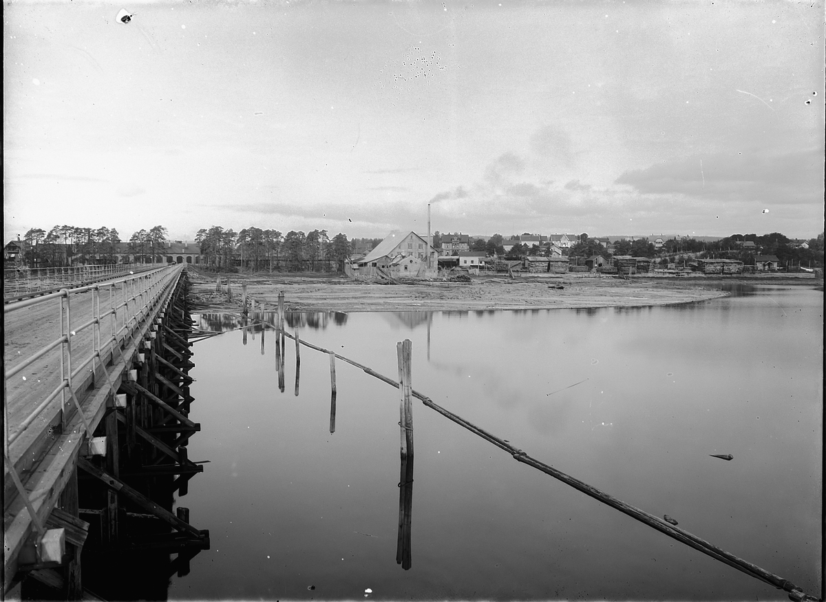Oscar Løberg, Stangebrua i Åkersvika, Hamar. Indahlssaga som vi ser på bildet ble startet i 1881av H. C. Indahl som var fra Toten. Han hadde også et landskjent frørenseri. Sagbruket brant senere ned. Bildet er tatt omkring 1917.