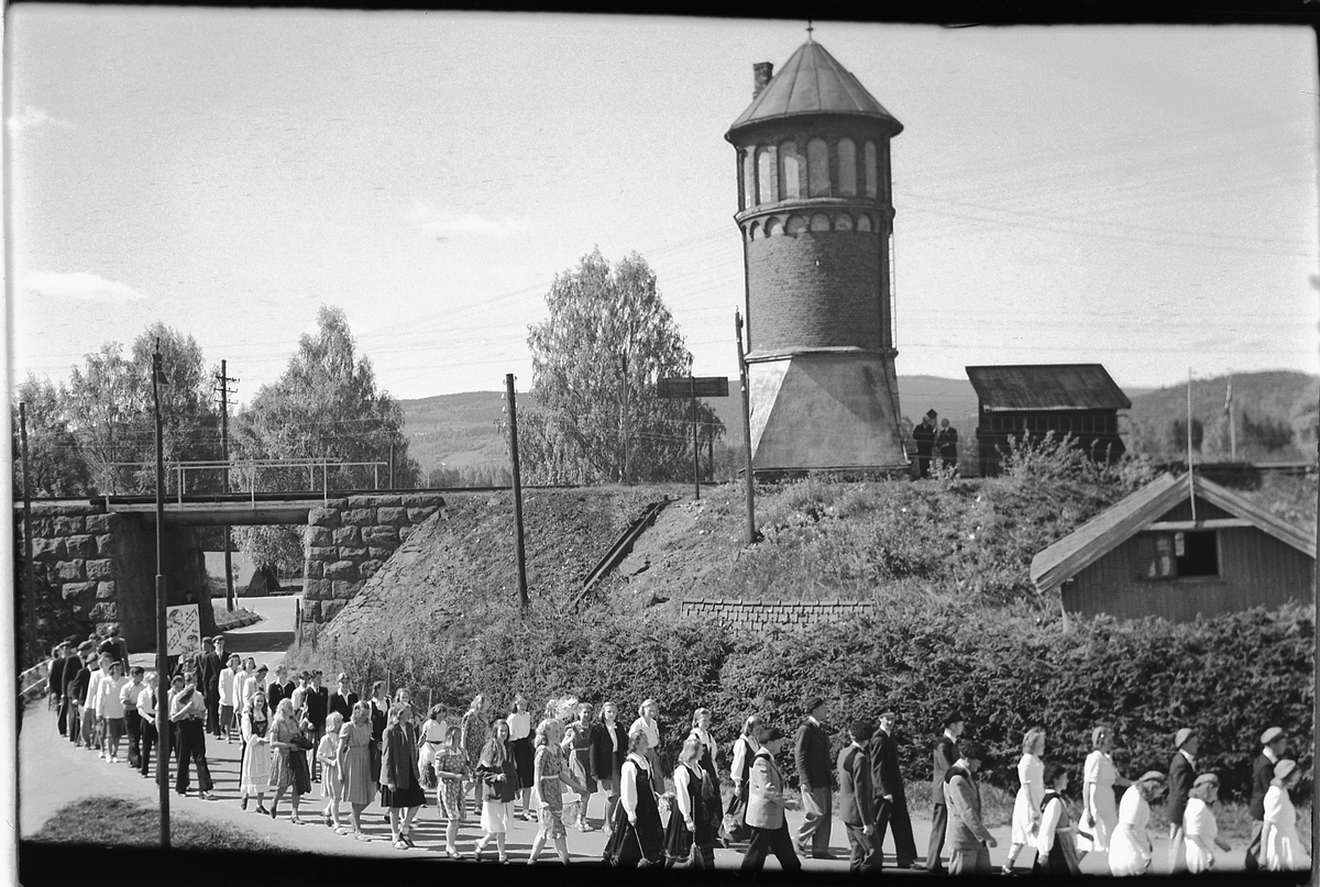 Håkon Prestkværn, 17. mai-tog i Moelv. VANNTÅRN VED MOELV JERNBANESTASJON, JERNBANEUNDERGANG NEDERST I STORGATA.
