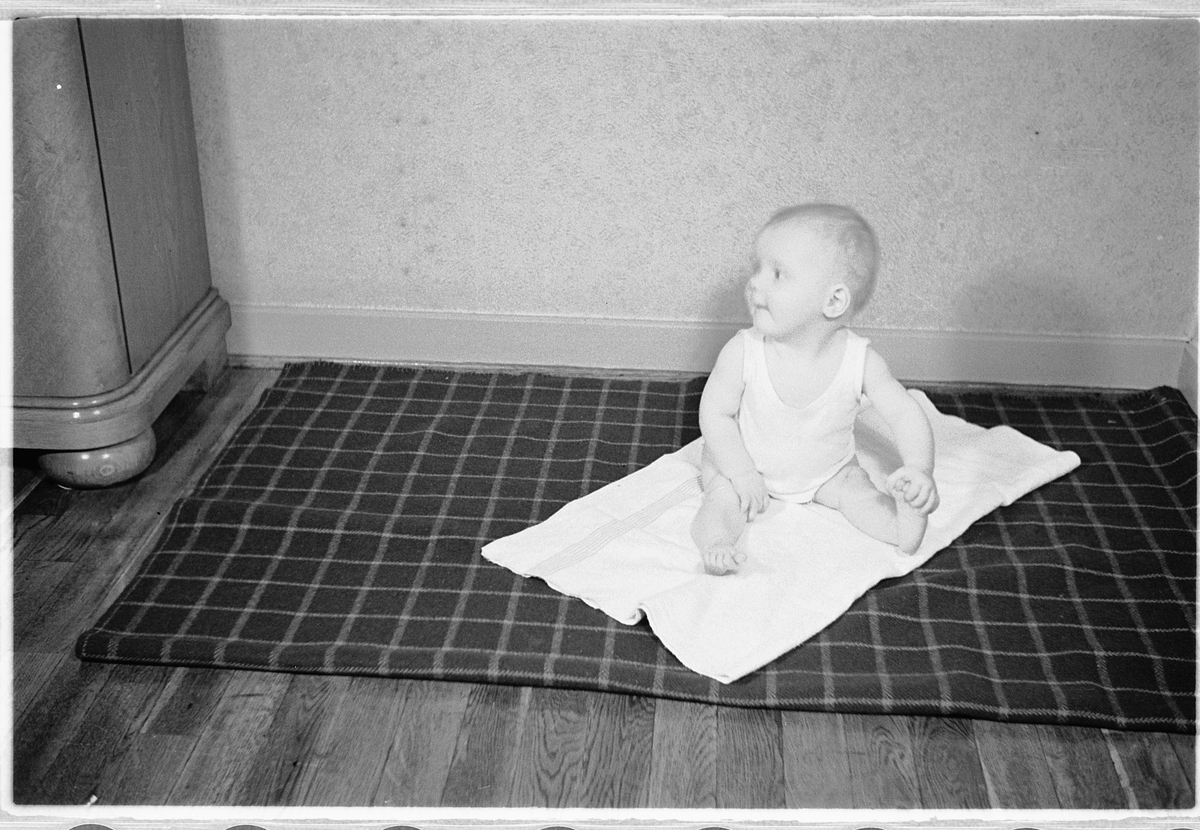 Håkon Prestkværn, En baby på et pledd.