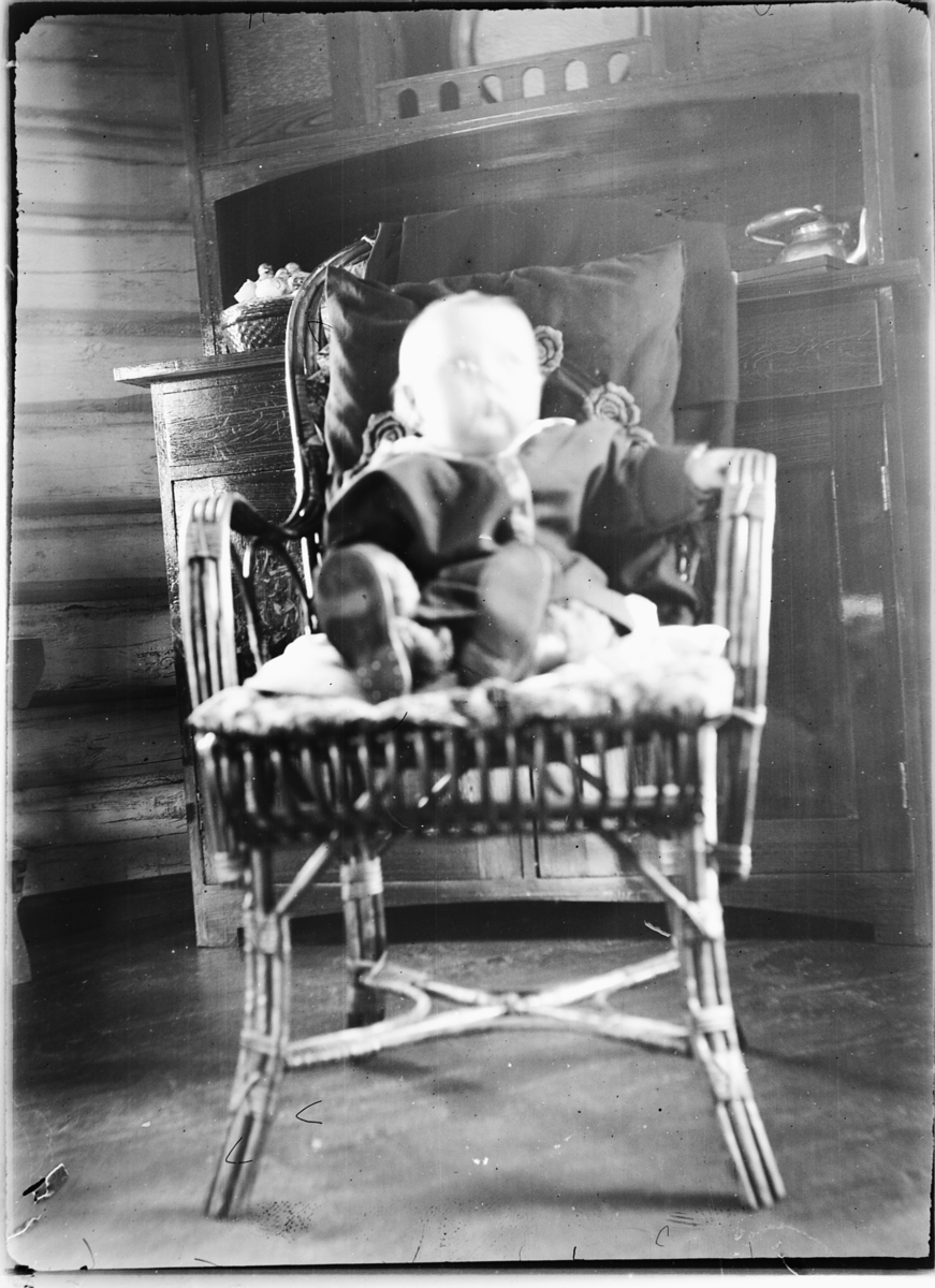 Ole M Martinsen, Interiør, stue. En baby sitter i en stol.