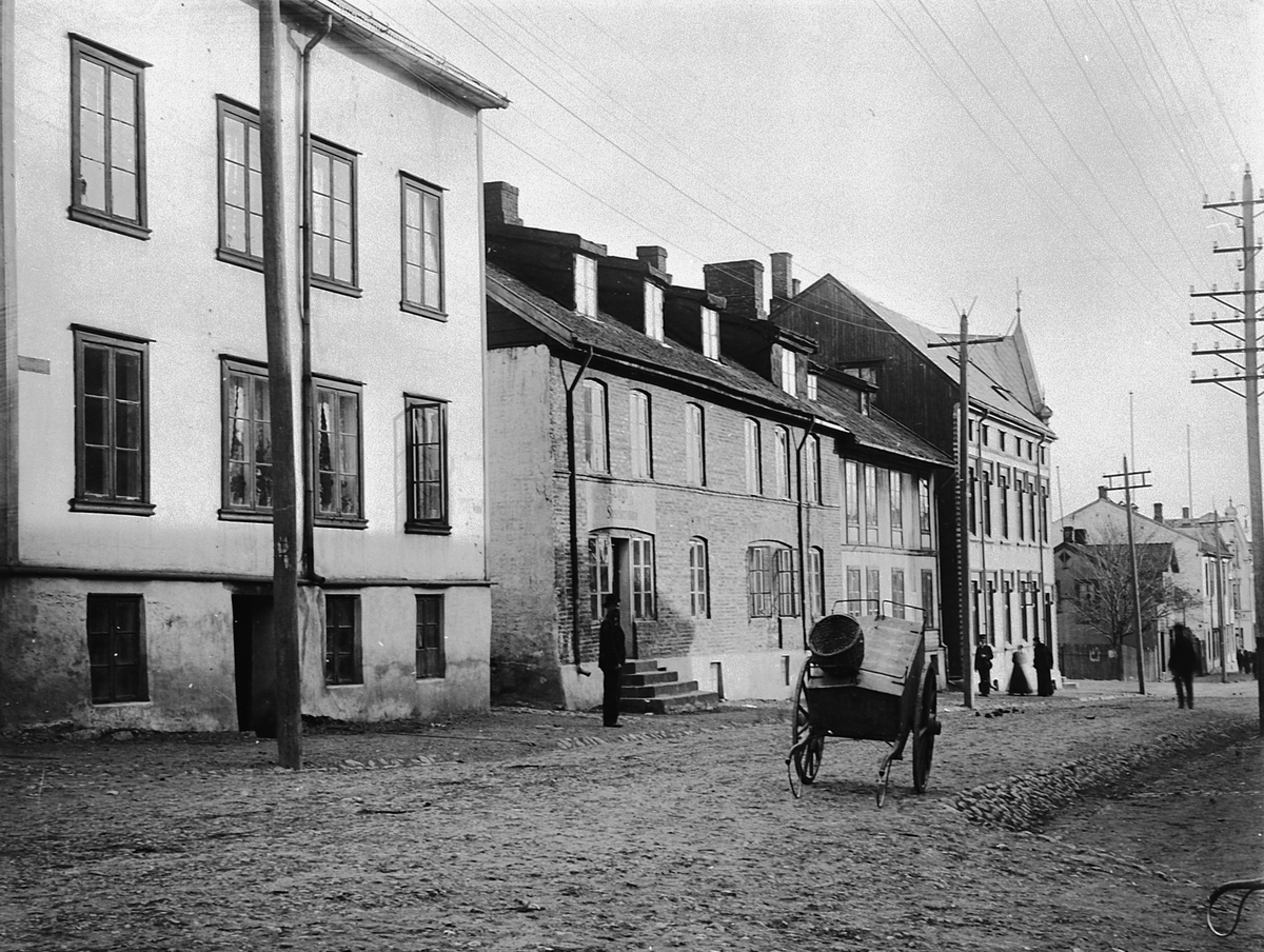 Hans Emil Erichsen, Grønnegata 61-63 i Hamar. Folk. Håndkjerre. Røverborgen til venstre.