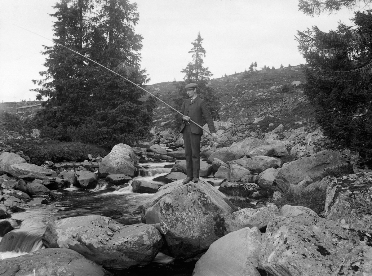Simen Baardseth, SIMEN BAARDSETH MED FISKESTANG i Skollelva, Ringsaker, nedenfor Snultra seter. Fuglsengsetra bak tv.
