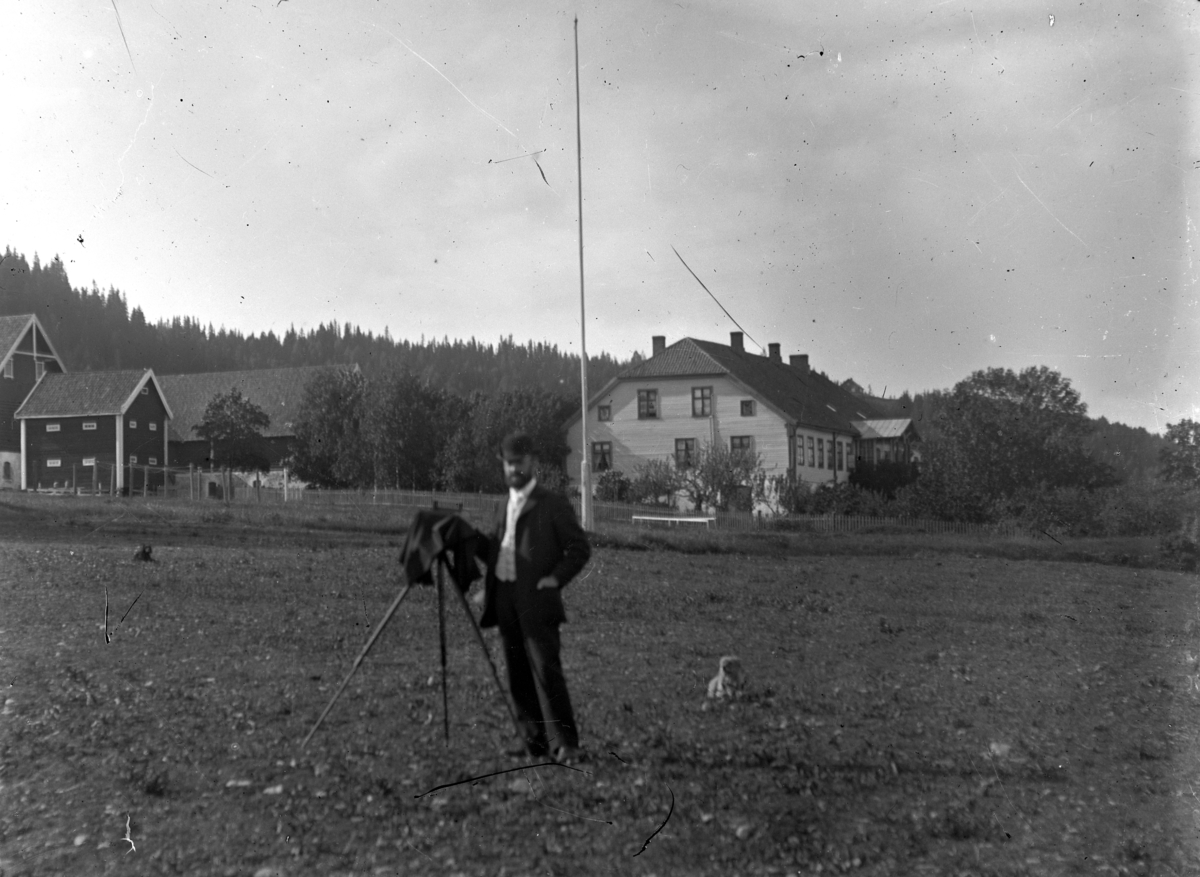 Martin Finborud, Grefsheim gård på Nes, Hedmark. En mann med et fotografiapparat i forgrunnen.