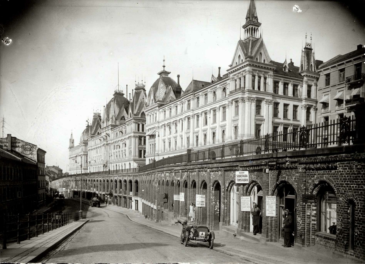 Hermann Christian Neupert, Victoria terrasse, Oslo. Sett nedenfra med basarene. En parkert bil i forgrunnen.