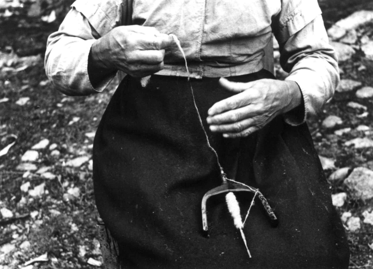 Anna Grostøl, Vinje, Rauland, Telemark 1939. Gro Vå spinner på håndtein.