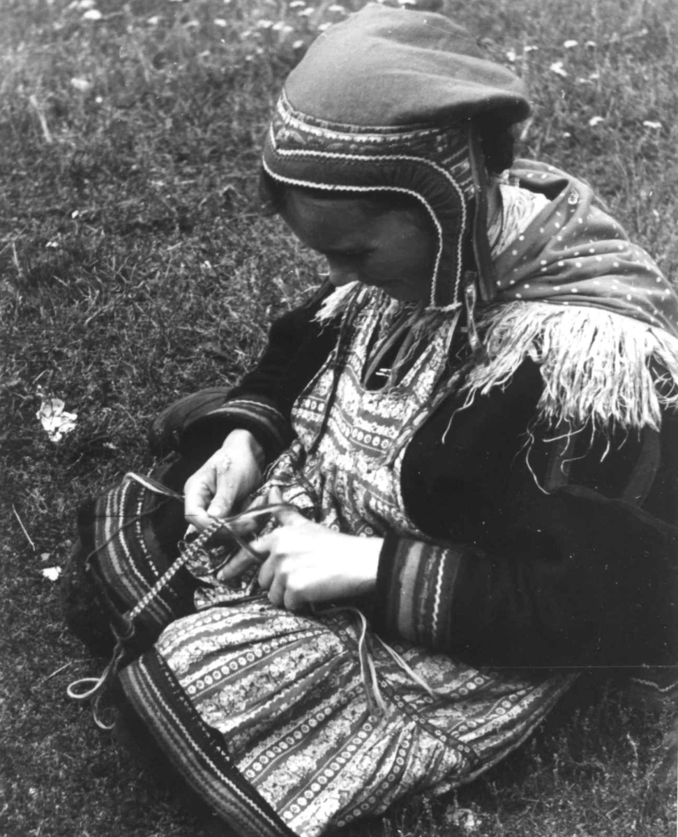 Anna Grostøl, En kvinne fletter bånd. Olderdalen, Kåfjord, Troms 1947.