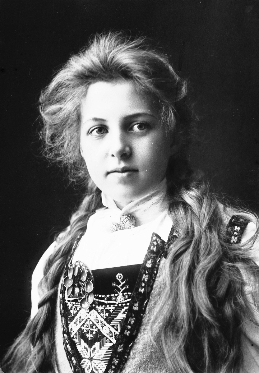 Solveig Lund, Studioportrett av kvinne i drakt med fletter.