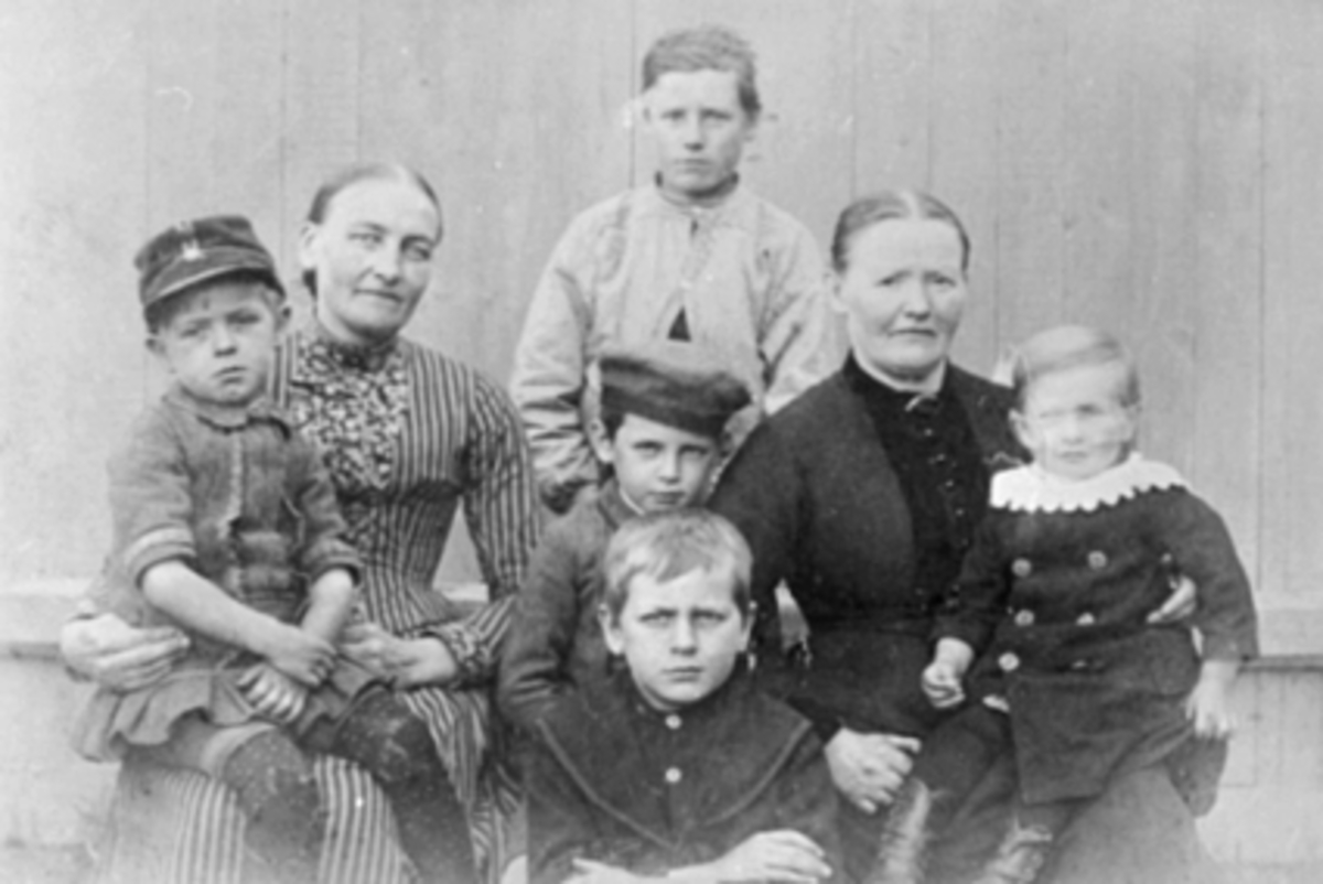 Anno Domkirkeodden, Hans Emil Erichsens 5 barn og hushjelper Elin Halvorsen til venstre. Eline Halvorsen var Hamars første menighetssøster.Til høyre er kokke Berthe Gurine Pedersdtr f. 1844 på Skudenæs. I 1900 bodde Hans og Jacobine Erichsen i Pastor Erichsens gård, md barna Hans Ole f. 1878, Halvor f. 1882, Johannes …