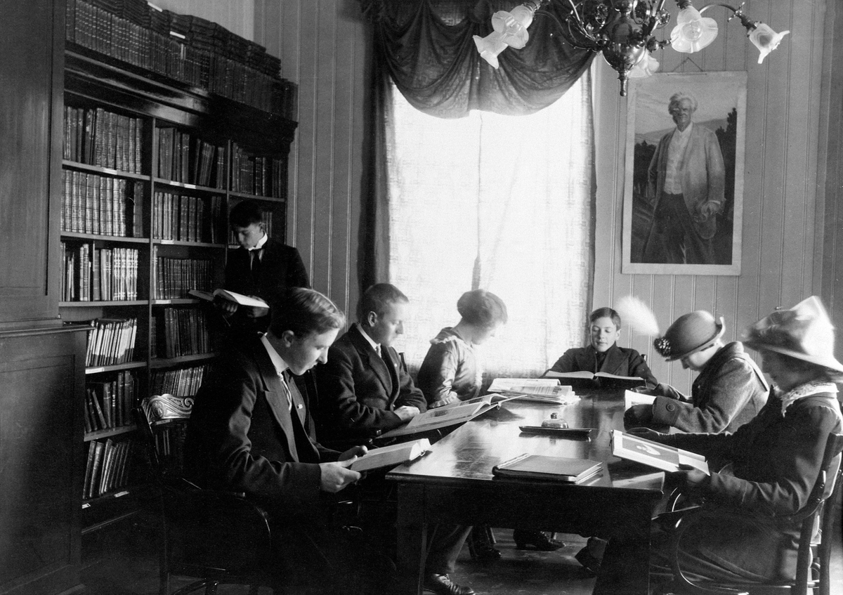 Anno Domkirkeodden, INTERIØR, HAMAR FOLKEBIBLIOTEK, GRUPPE V/BORD, BIBLIOTEKET HAR VÆRT I: BRANNVAKTA/MIDTBYEN 1888-1890, HÅNDVERKERN, PARKGT. 1890-1892, MIDTBYEN SKOLE 1892-1909, HÅNDTVERKEREN, PARKGT. 1909-1925, SAMLAGSGÅRDEN, TORGGT. 631925-1943 BRANN, MIDTBYEN SKOLE 1943-1947, PIKESKOLEN 1947-1952HANDELENS HUS, ST…