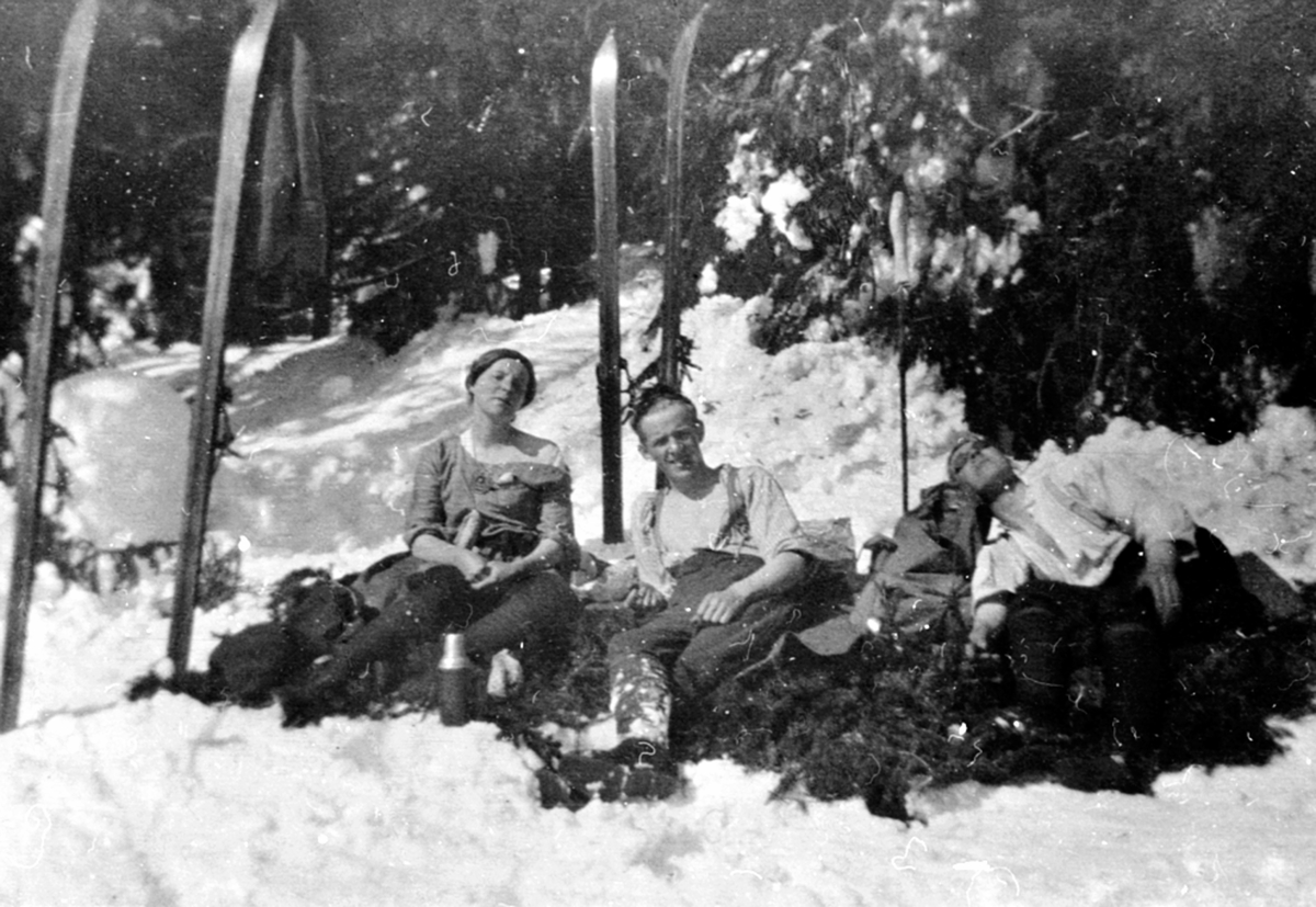 Anno Domkirkeodden, Tre personer på påsketur soler seg. Skiutstyr. Løken, Ringsaker.