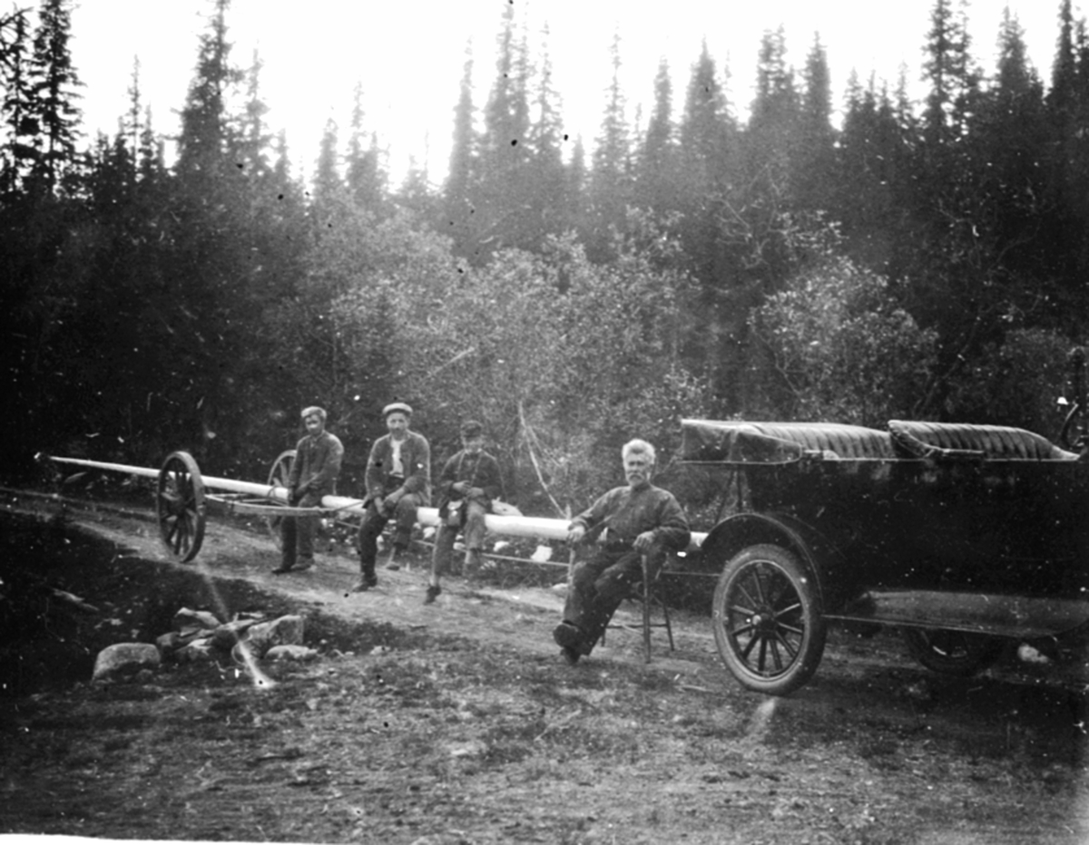 Anno Domkirkeodden, Transport av flaggstang med bil og kjerre. Til høyre i stolen er Ole Harkerud. Tre menn på flaggstanga. Tannlege Karl Løken Jr. har vært i Mesnalia og kjøpt flaggstang. Bilen, D-111 er en Ford T 1919-22 modell.