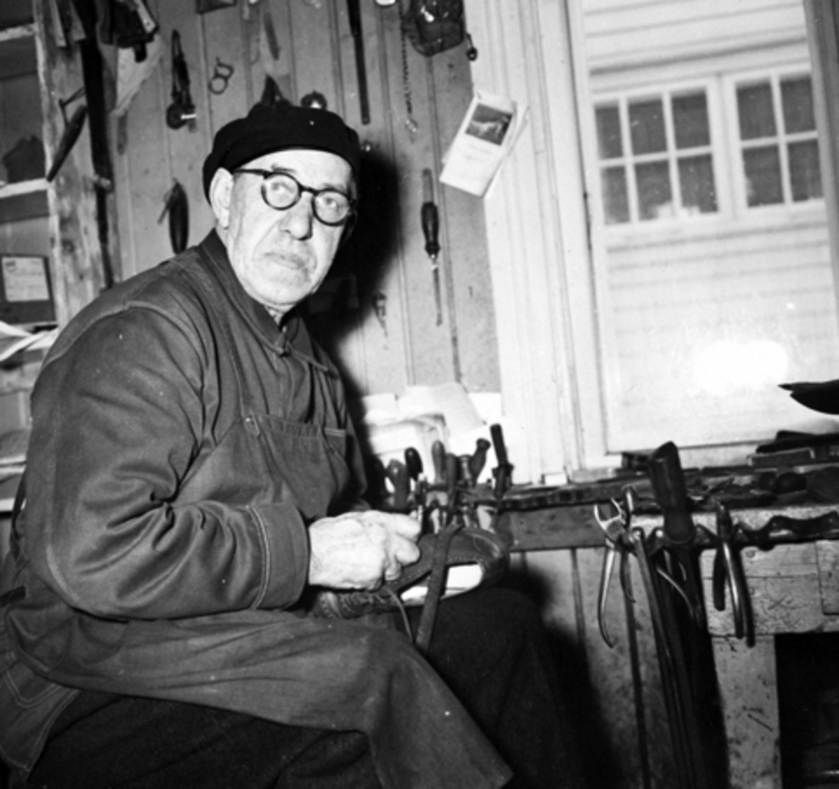 Anno Domkirkeodden, Interiør, skomakerverksted, skomaker Aksel Ludvig Andersen (1887-1966) reparerer sko. Heimdal, Gamlegata 12, Brumunddal.