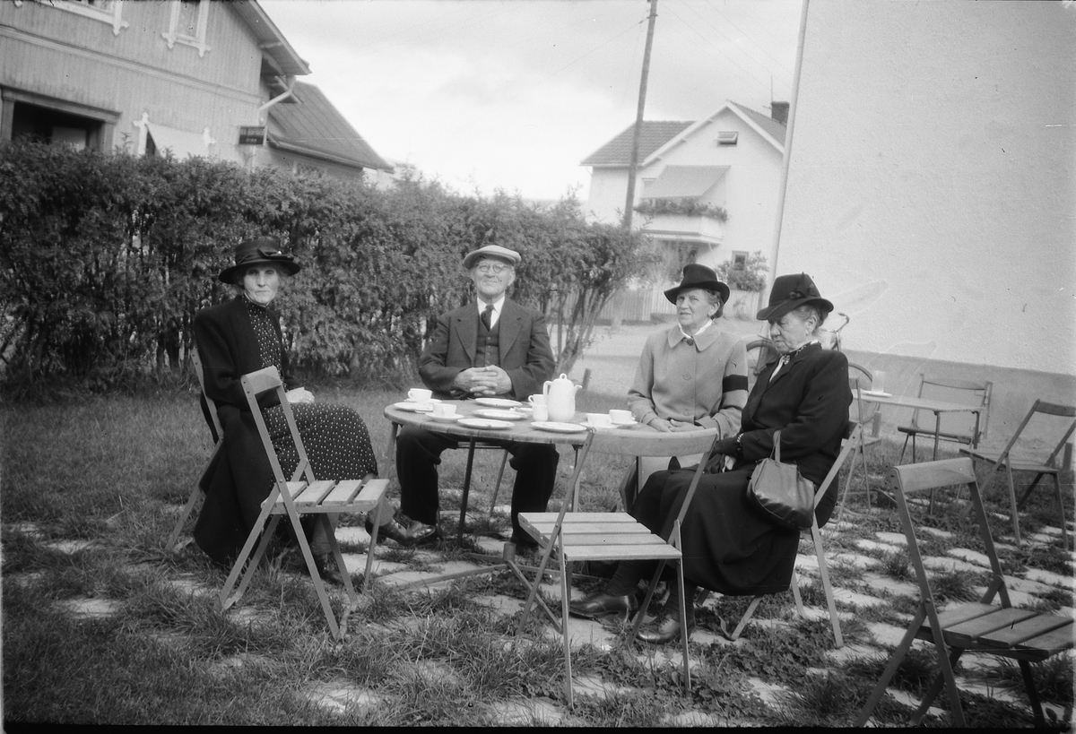 Håkon Prestkværn, Ukjente personer rundt et hagebord.