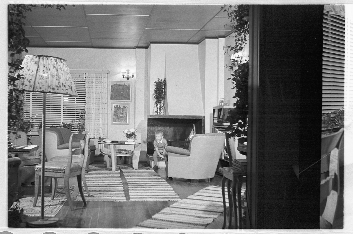Håkon Prestkværn, Interiør, stue med sofa, stålampe og peis.
