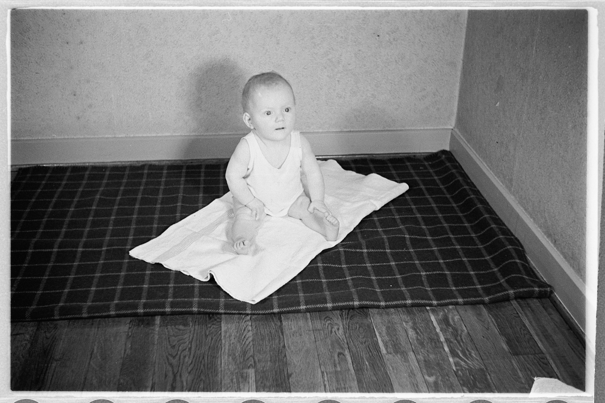 Håkon Prestkværn, En baby på et pledd.